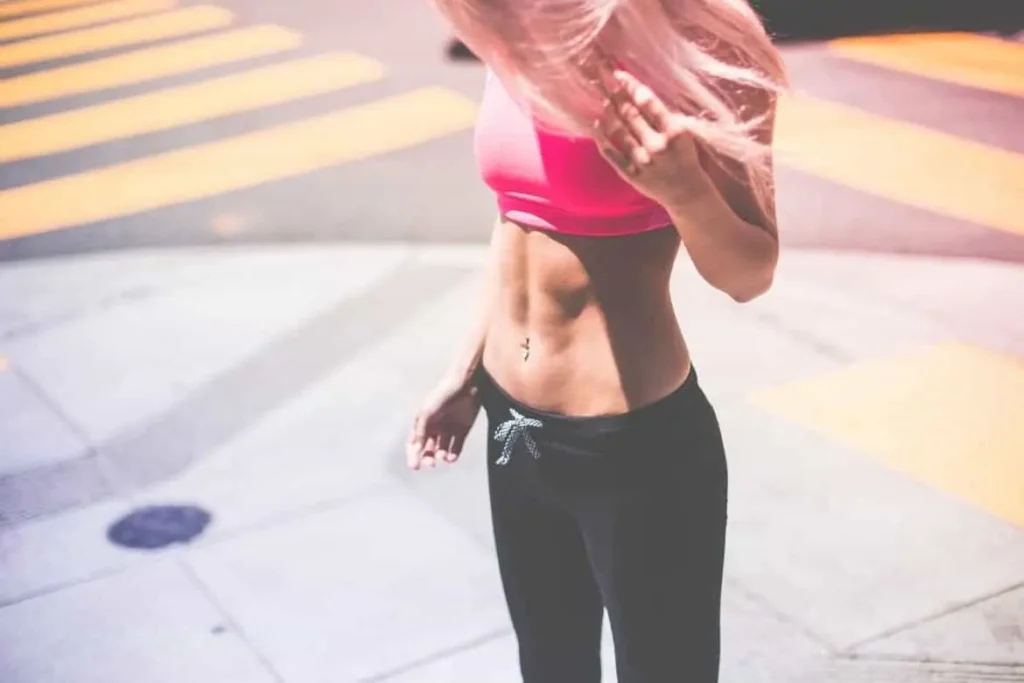 Woman with toned stomach after LA-EMS Body Sculpting Treatment Reading